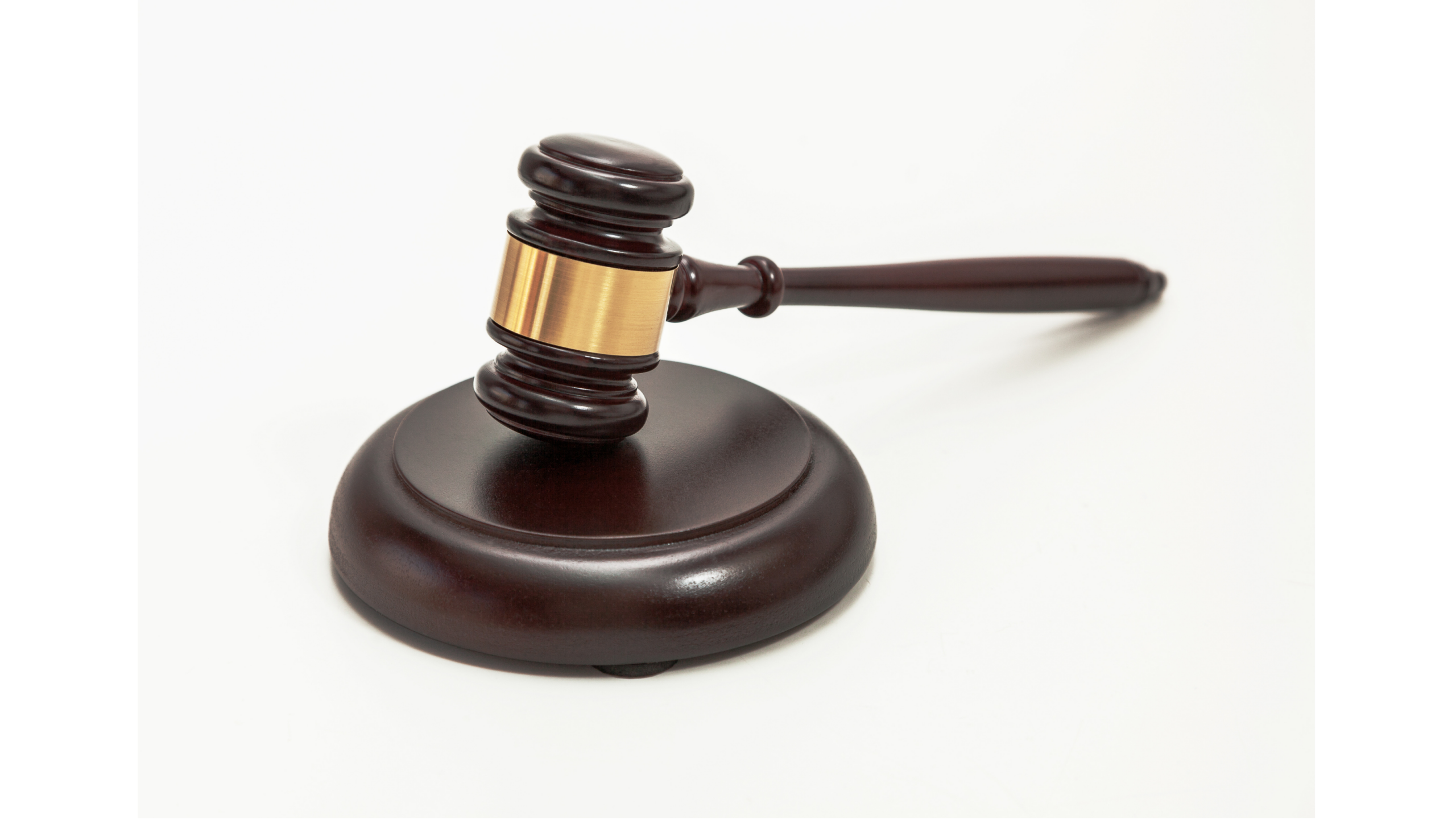 Scales of justice and gavel in a stylized modern legal setting